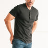 Batch Men's Essential Short Sleeve Curved Hem Henley – Black Cotton Jersey Image On Body Standing