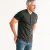 Batch Men's Essential Short Sleeve Curved Hem Henley – Black Cotton Jersey Image on Body Standing with Hands in Pockets