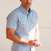 Editor Two Pocket Short Sleeve Men's Utility Shirt In Classic Blue Cotton Pinpoint Oxford On Body Close-Up Image